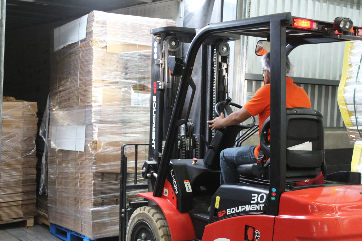 Carga de empaque agrícola a transporte en andén de Mely Packaging